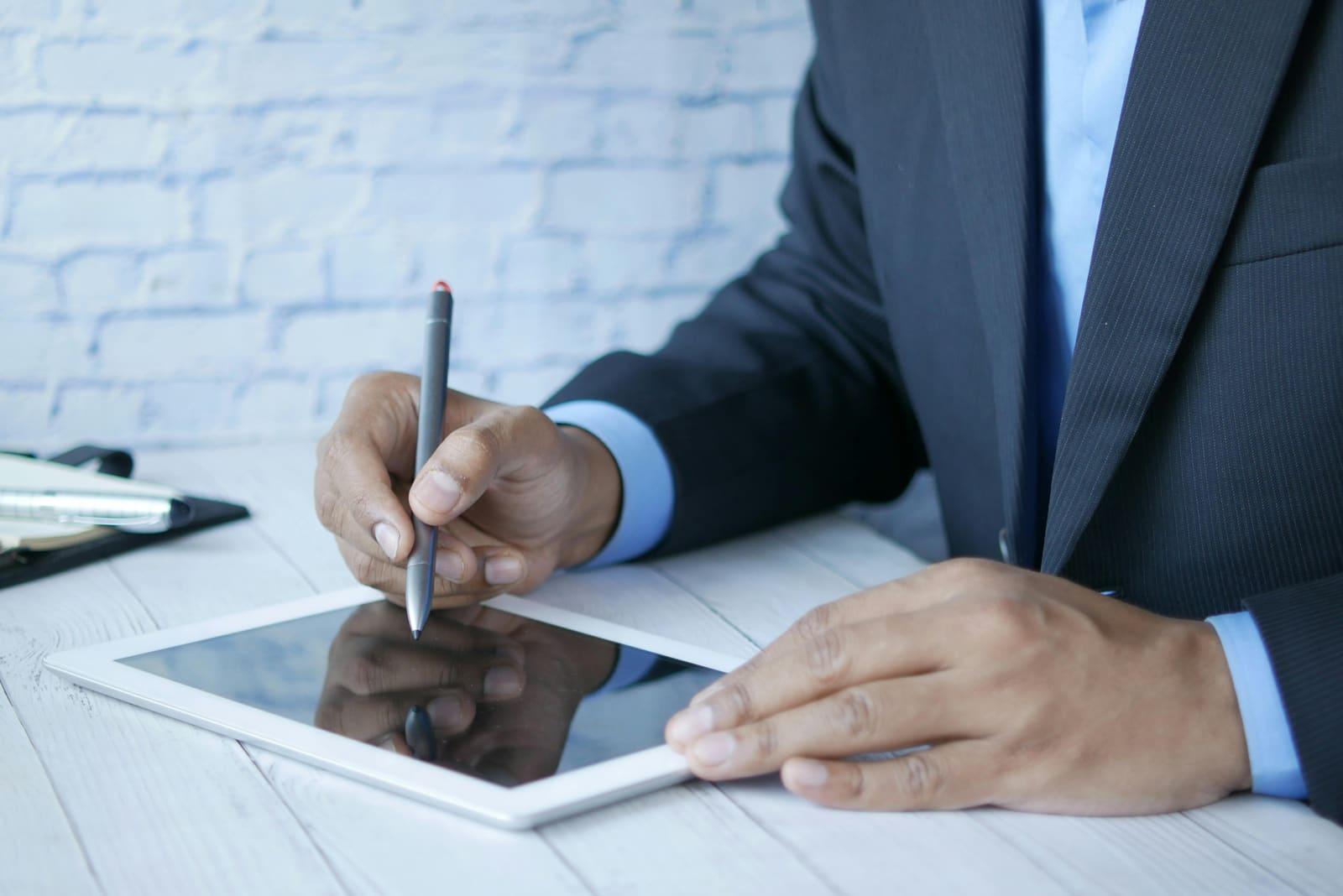 An accountant working on a tablet with a stylus