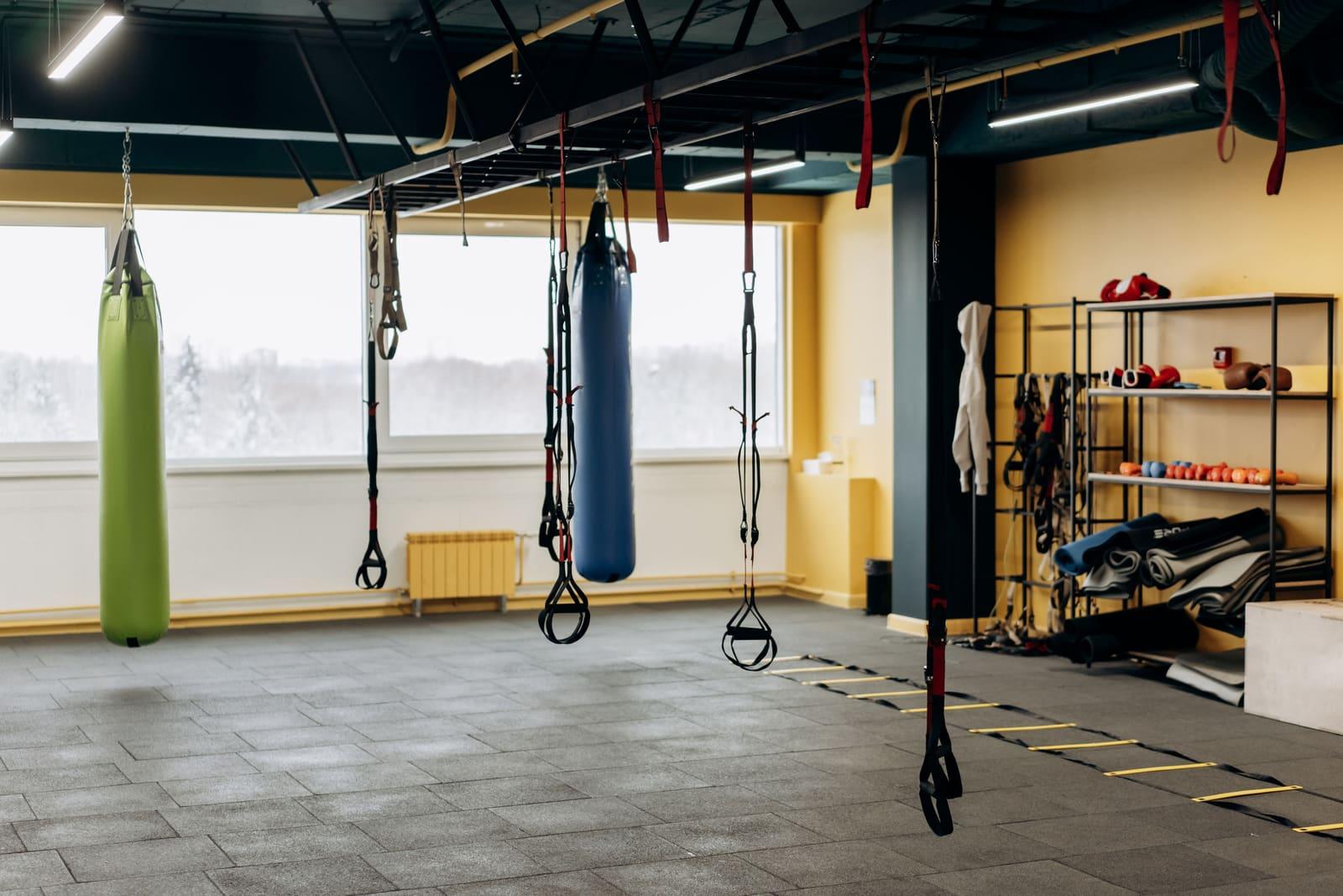 The interior of a modern gym with training equipment.