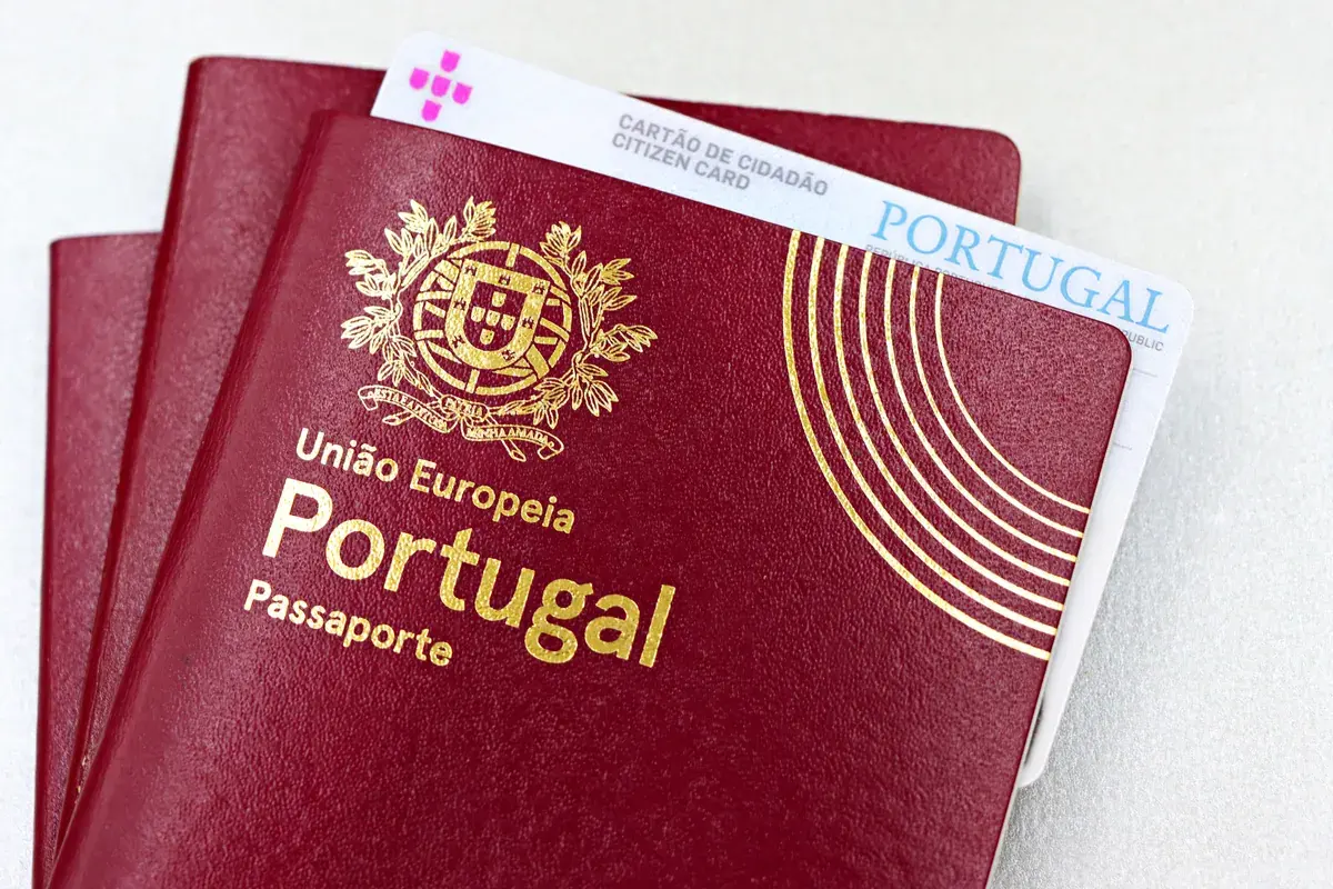 Two passports and a national identity card resting on a plain white surface