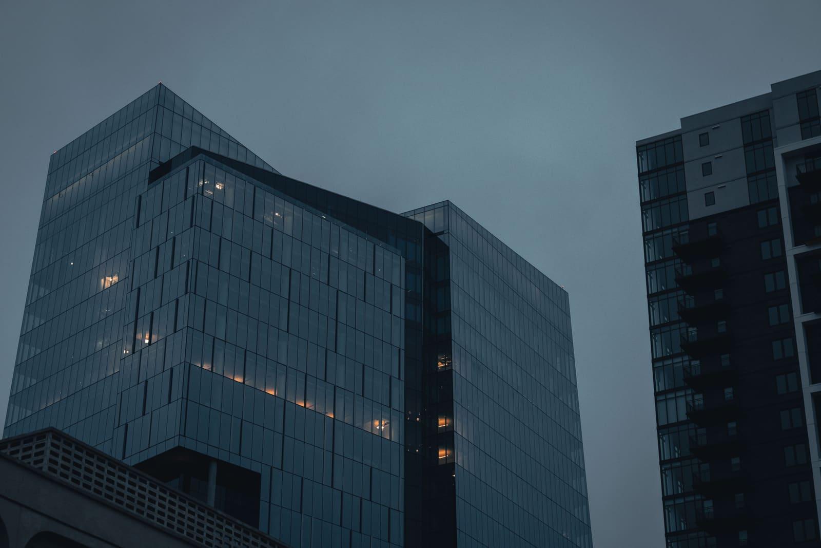 Modern glass office towers rising against a dusk sky