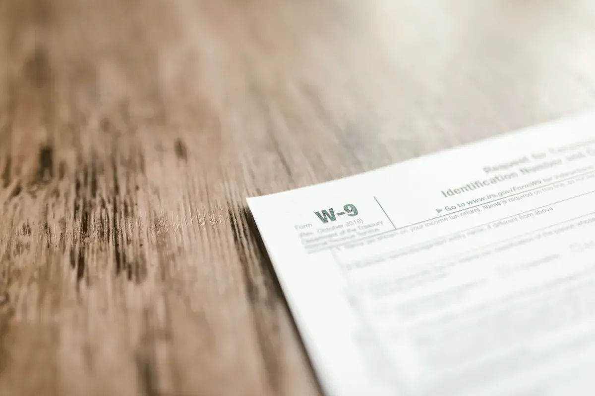 A close-up of a printed federal tax form resting on a wooden work surface
