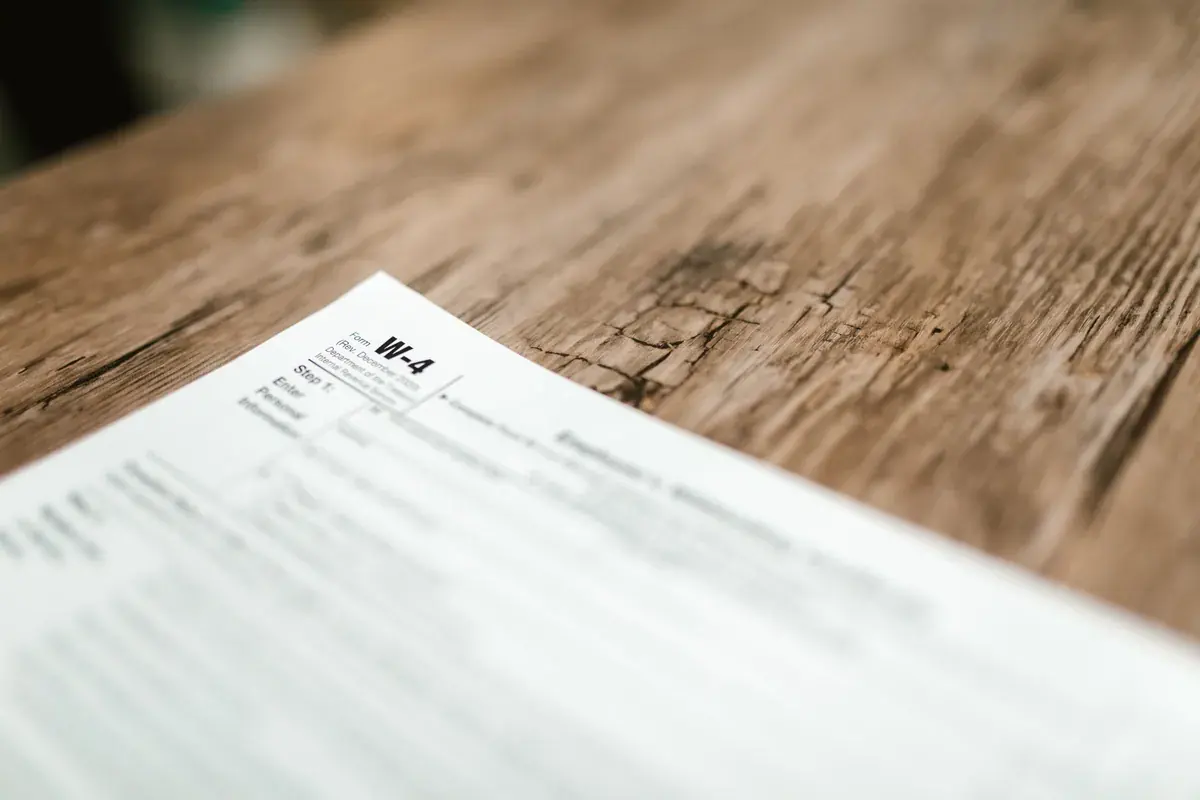 A close-up of a printed federal tax form on a rustic wooden table