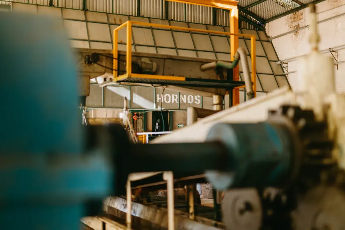 Close-up of heavy manufacturing equipment and conveyor systems on a factory floor