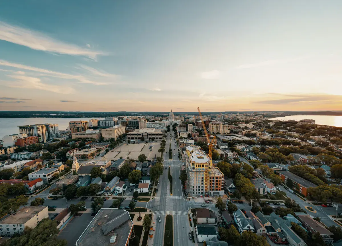 Aerial view of a state capital city at sunset with a domed capitol in the distance