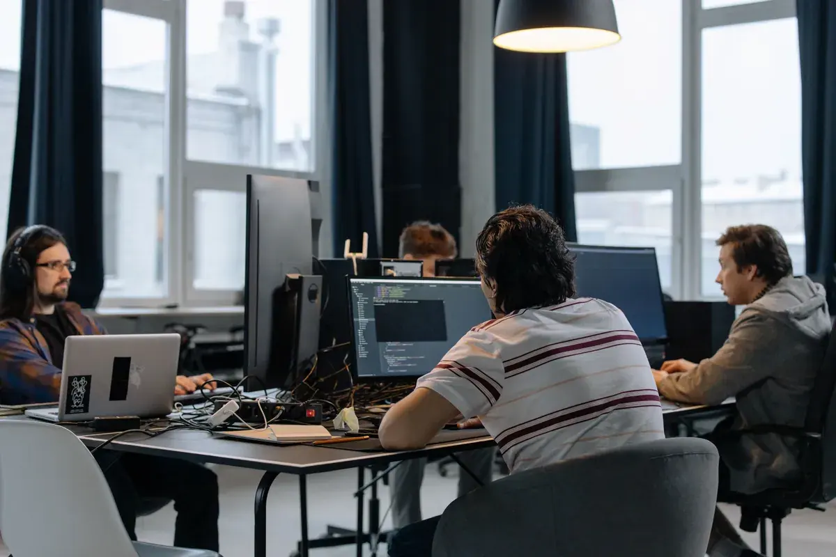 Software developers working at monitors in a bright open plan office