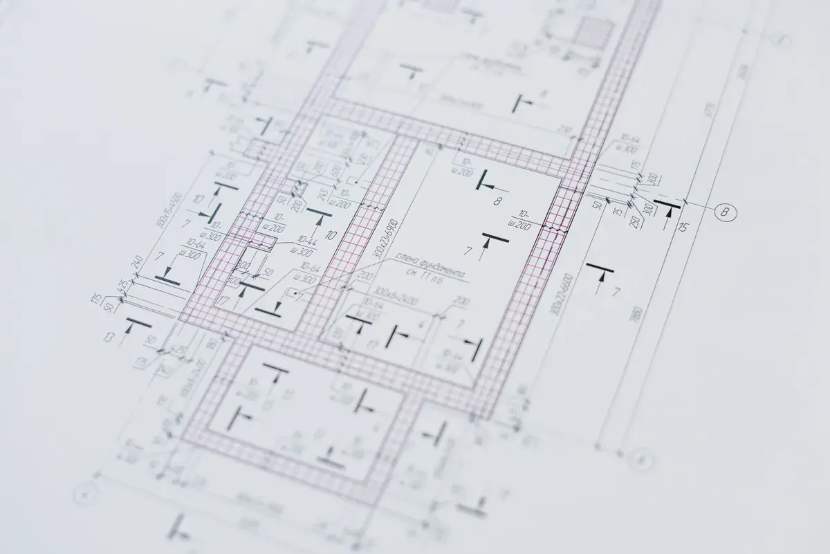 Close view of a technical drawing sheet covered in dimension lines, callouts, and detail annotations.