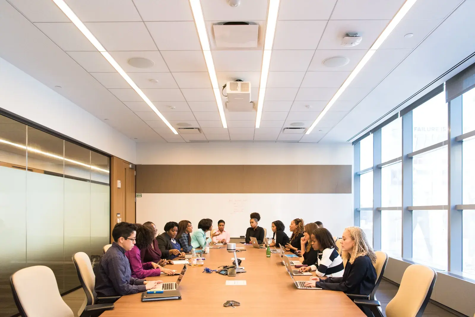 A multicultural team of professionals collaborating around a conference table during a workplace planning meeting